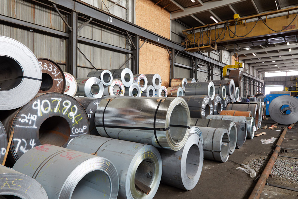 Rows of flat rolled steel coils in a steel warehouse