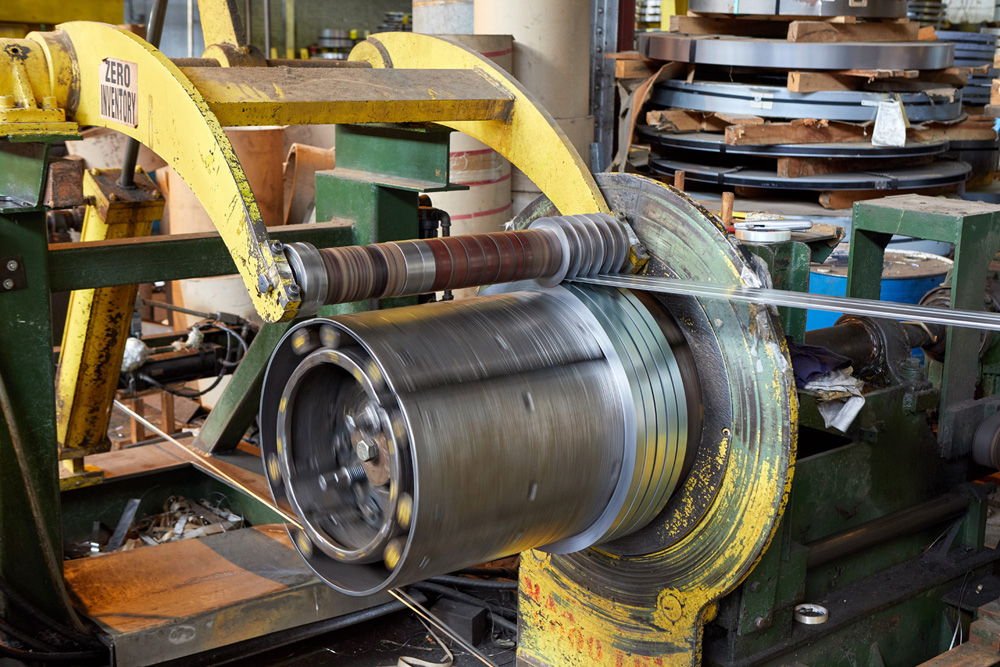 Narrow slitting a flat rolled steel coil on a processing line