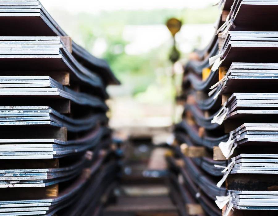 Stacked flat rolled steel plate in a warehouse